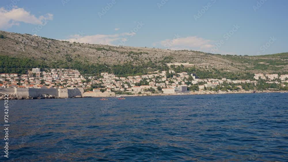 People Kayaking On Sea Near Dubrovnik City People Kayaking On Sea Near Dubrovnik City