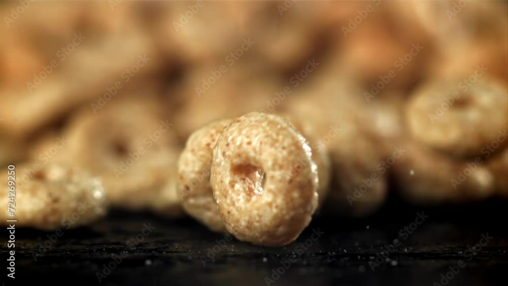 Corn flakes falling on black background. Filmed on a high-speed camera at 1000 fps. High quality FullHD footage