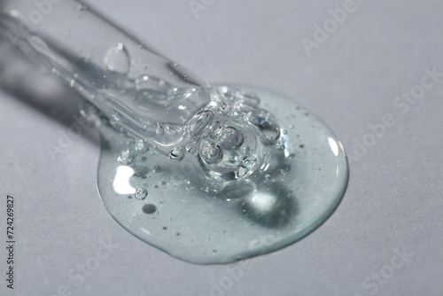 Pipette with cosmetic serum on white background, macro view © New Africa