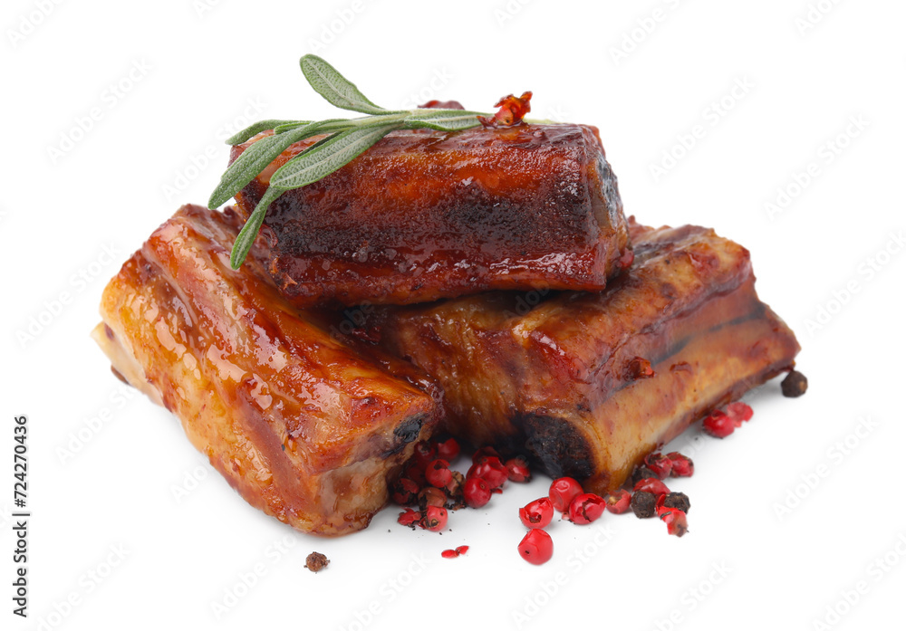 Tasty roasted pork ribs, rosemary and peppercorns isolated on white Tasty roasted pork ribs, rosemary and peppercorns isolated on white