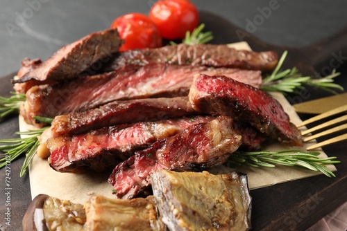 Delicious grilled beef with vegetables and rosemary on table, closeup
