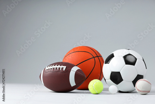 Many different sports balls on light gray background  space for text