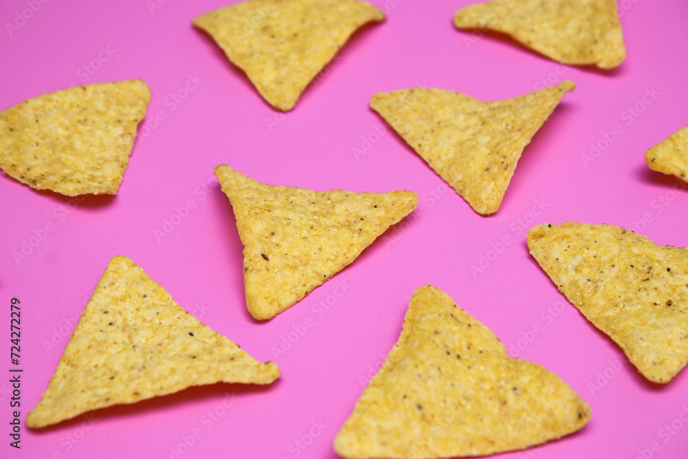 Tortilla chips isolated on bright pink background Tortilla chips isolated on bright pink background