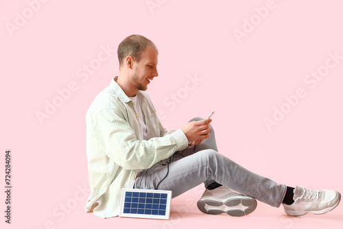 Young man charging mobile p...