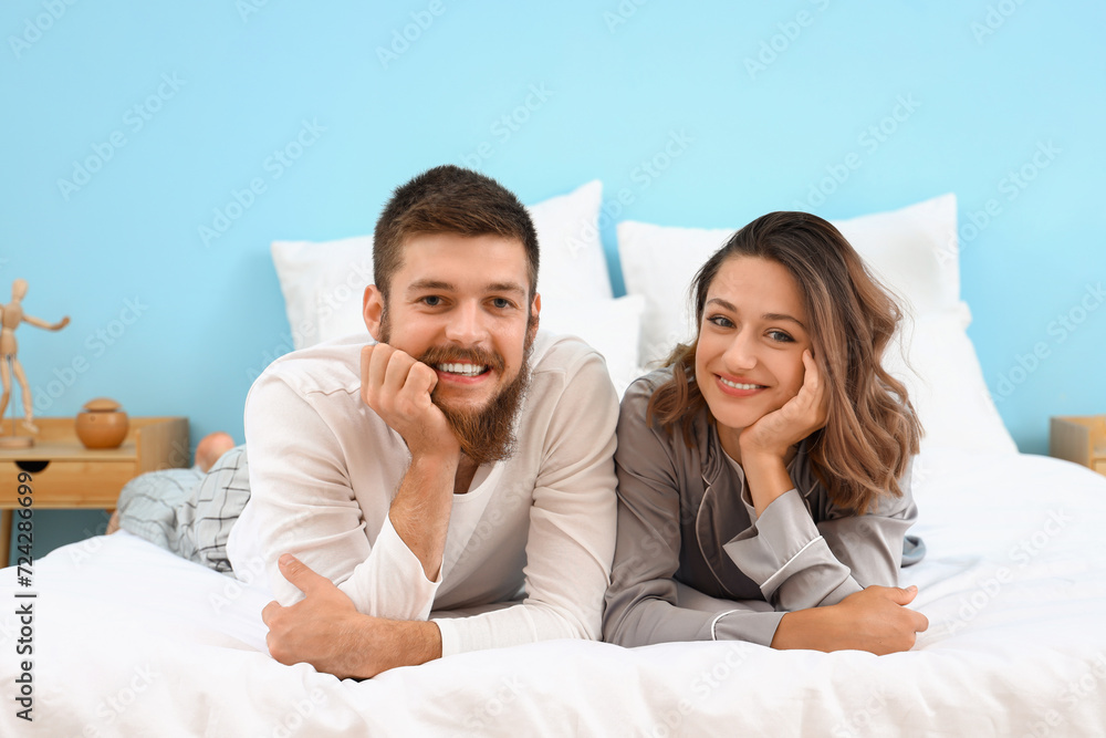 Happy couple in love lying in bedroom Happy couple in love lying in bedroom