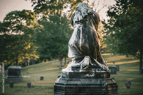 Ethereal Sculpture of a Grieving Woman Stands Vigil in the Cemetery