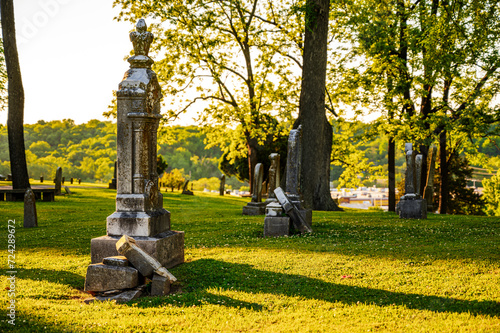Golden Hour Illumination Over Cemetery Monuments and Serene Landscape