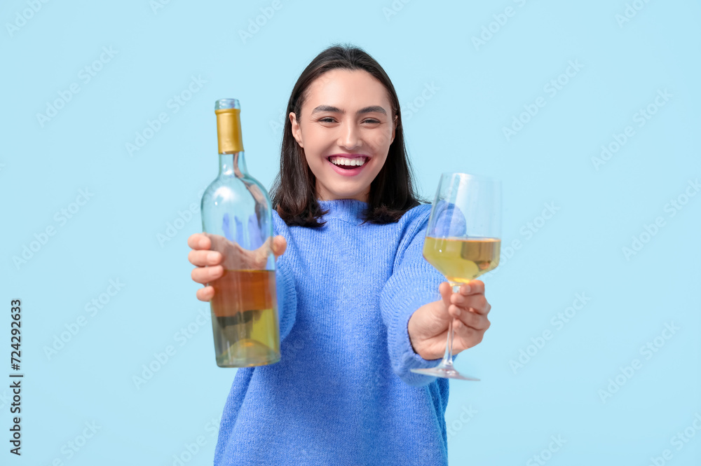 Beautiful young woman with glass and bottle white of wine on blue background Beautiful young woman with glass and bottle white of wine on blue background