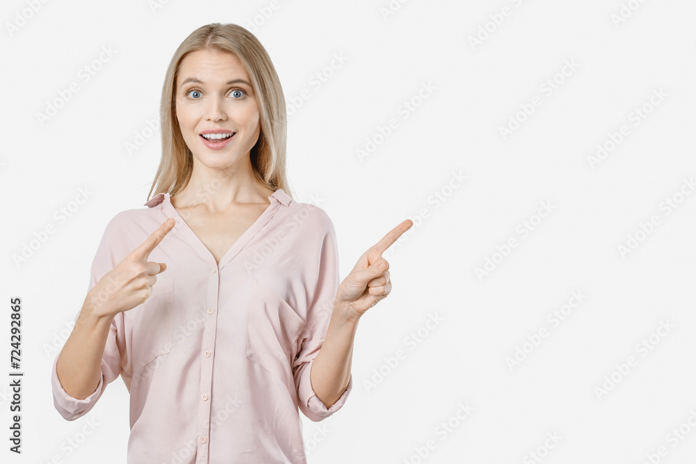 Portrait of surprised pretty young woman pointing with two fingers. Copy space free empty space place. Advertisement concept Portrait of surprised pretty young woman pointing with two fingers. Copy space free empty space place. Advertisement concept