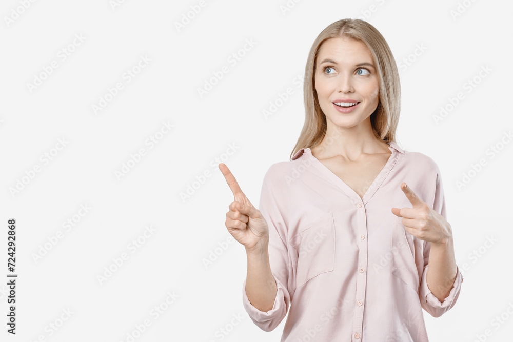 Cute young woman looking aside while standing isolated over white background pointing. Copy space free empty space place. Advertisement concept Cute young woman looking aside while standing isolated over white background pointing. Copy space free empty space place. Advertisement concept