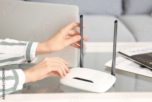 Woman with modern wi-fi rou...