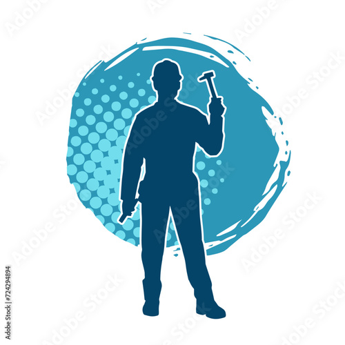 Silhouette of a worker carrying hammer tool. Silhouette of a worker in action pose using hammer tool.