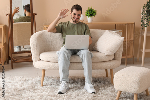 Handsome young man using la...