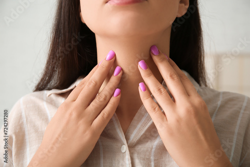 Young woman with thyroid gland problem at home, closeup