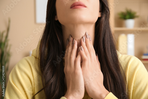 Young woman with thyroid gland problem at home  closeup