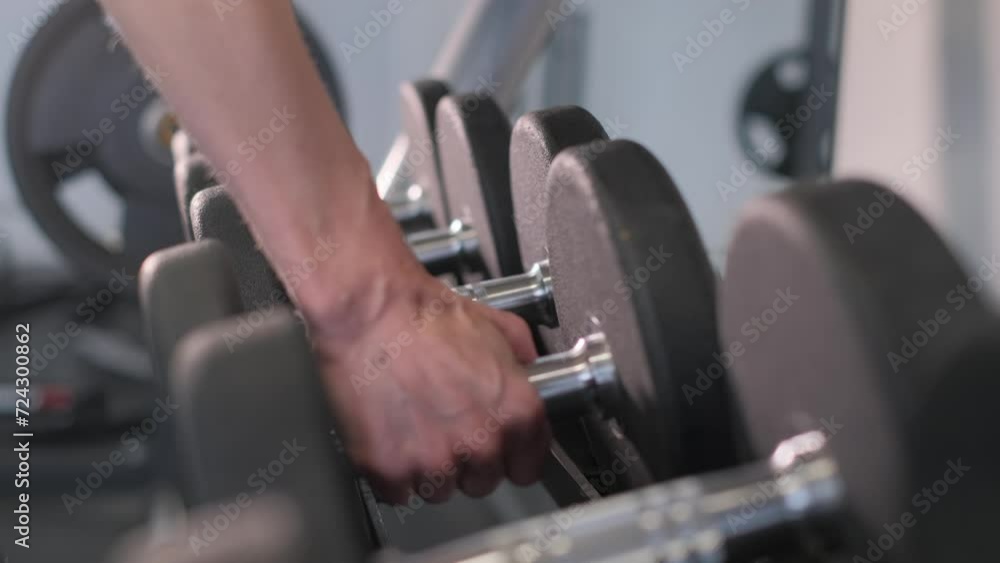 Close-up of a woman's hands in the gym lifting dumbbells. Sport concept Close-up of a woman's hands in the gym lifting dumbbells. Sport concept