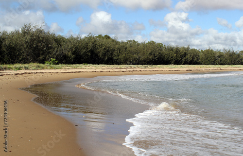 Canoe Point beach with the ocean, sand and trees at Tannum Sands in Queensland, Australia