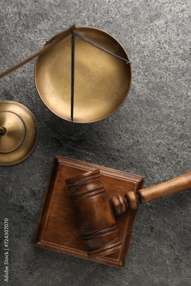 Law concept. Judge's mallet and scales of justice on dark grey table, top view