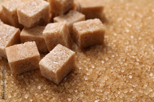 Different types of brown sugar as background, closeup. Space for text
