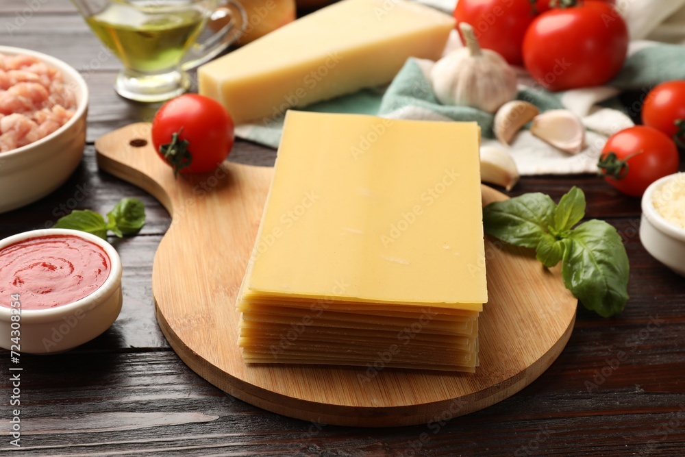 Uncooked ingredients for lasagna on wooden table Uncooked ingredients for lasagna on wooden table