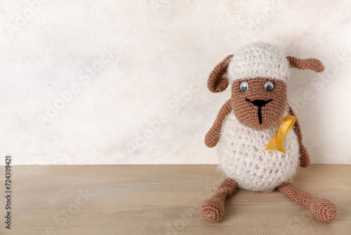 Toy sheep with golden ribbo...