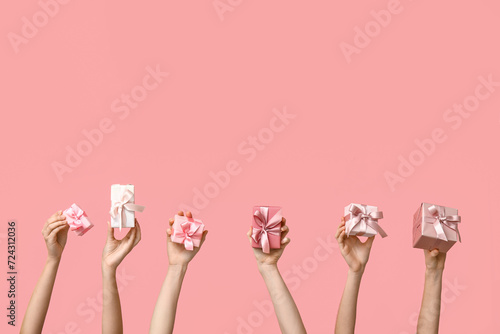 Women with gifts on pink background. Mother's Day celebration