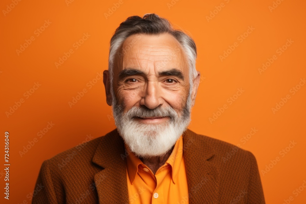 Portrait of a senior man with grey beard and mustache. Isolated on orange background. Portrait of a senior man with grey beard and mustache. Isolated on orange background.