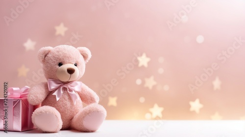 A soft pink teddy bear accompanied by a gift box on a pastel background with starry effects, suggesting a holiday or birthday present.