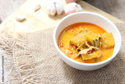 Red Curry Pumpkin with pork served on wooden table, delicious Thai food popular in Thailand, Asia food.
