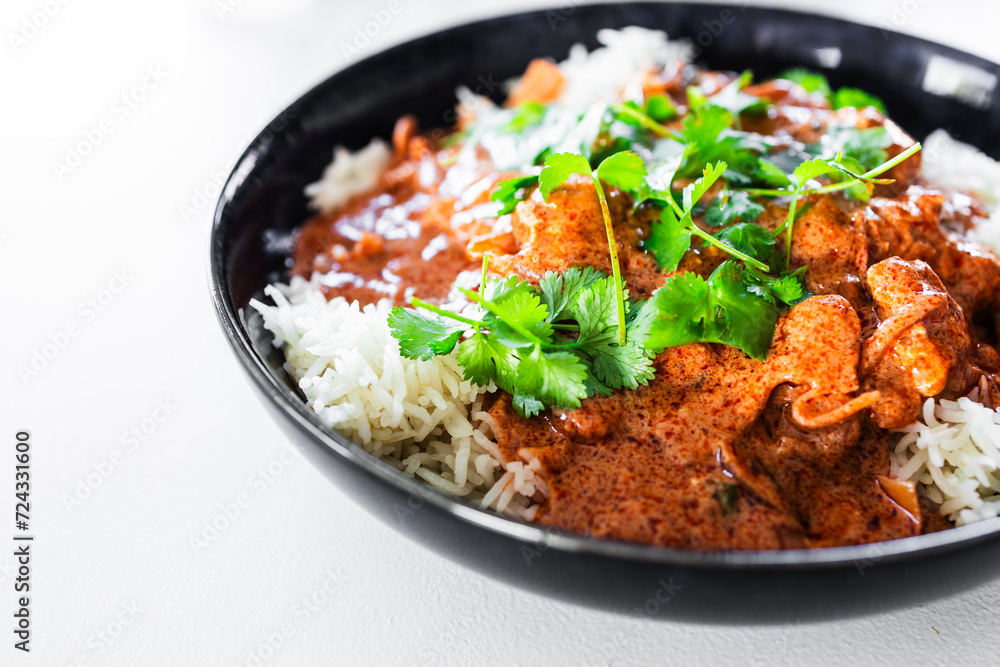 plant-based butterchicken with tofu chunks and white rice tooped with coriander plant-based butterchicken with tofu chunks and white rice tooped with coriander