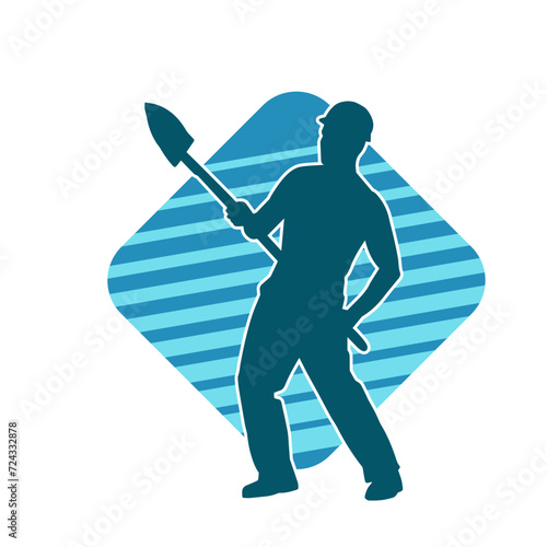 Silhouette of a worker carrying shovel tool. Silhouette of a worker in action pose using shovel tool. 