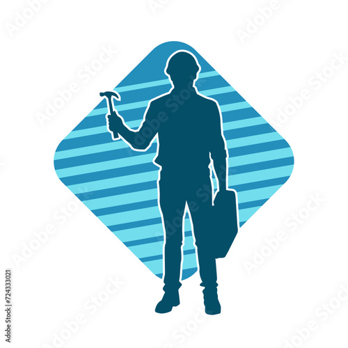 Silhouette of a worker carrying hammer tool. Silhouette of a worker in action pose using hammer tool.