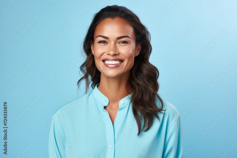 Portrait of happy smiling young woman in blue shirt, over blue background Portrait of happy smiling young woman in blue shirt, over blue background