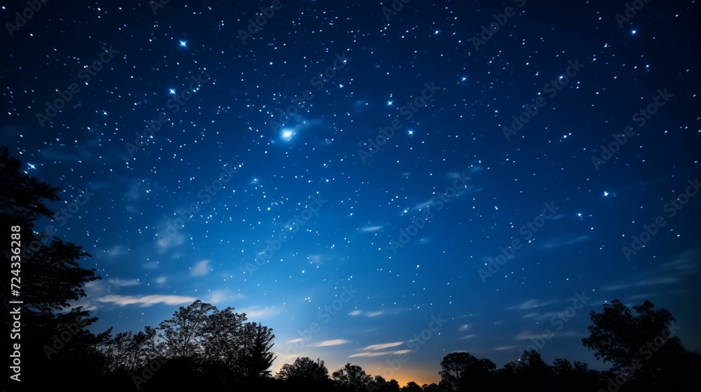 Naklejka premium The night sky, clouds and countless sparkling stars.