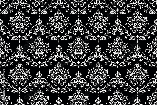 Wallpaper in the style of Baroque. Seamless vector background. White and black floral ornament. Graphic pattern for fabric, wallpaper, packaging. Ornate Damask flower ornament