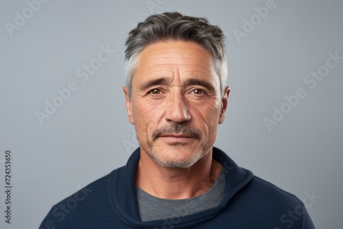 Handsome middle-aged man with grey hair and beard. © Iigo
