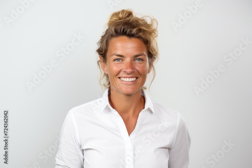 Portrait of a smiling businesswoman looking at the camera over white background