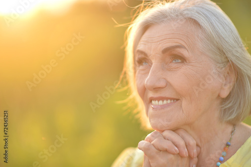 portrait of a happy senior woman in park