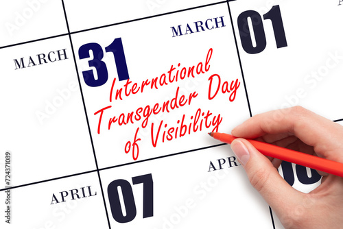 March 31. Hand writing text International Transgender Day of Visibility on calendar date. Save the date. photo