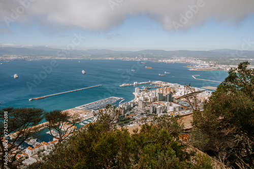 Gibraltar, Britain - January 24, 2024 - expansive view of Gibraltar, showcasing the port, densely packed buildings, and the bay against a mountain backdrop.