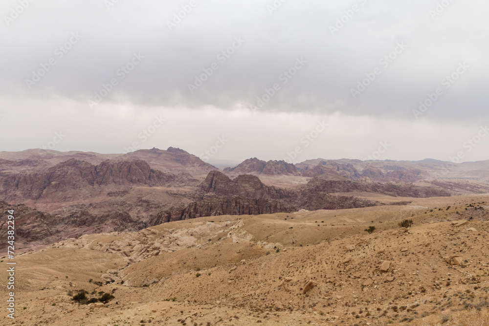 View from distance from the high hill to the famous gorge in which it is located thr Nabatean Kingdom of Petra in the Wadi Musa city in Jordan