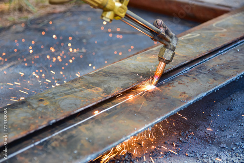 Worker cutting metal plate by Gas Cutting Torch