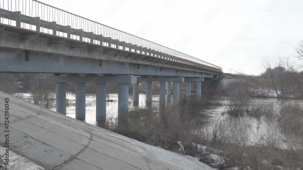 A bridge over a small river in high water in early spring A bridge over a small river in high water in early spring