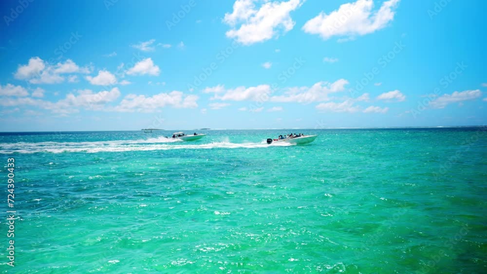 Two boats speeding on tropical ocean heading towards the Ile aux Fouquets. Boats rushing, seaside exploration. Exotic destination. Two boats speeding on tropical ocean heading towards the Ile aux Fouquets. Boats rushing, seaside exploration. Exotic destination.