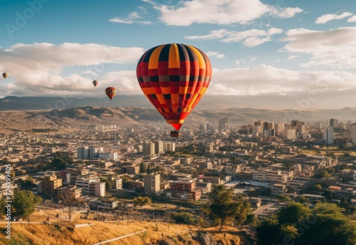 Group of Hot Air Balloons Soar Above City © we360designs