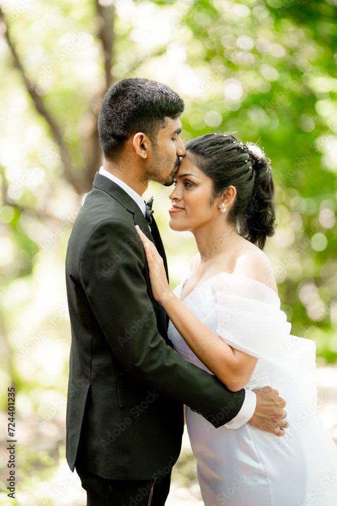 bride and groom in a forest, forehead kissing bride and groom in a forest, forehead kissing