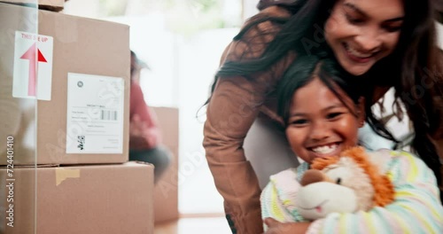 Box, family and children while playing in new home for mortgage, investment and moving house at front door. Parents, kids and cardboard or excited for ownership, relocation and commitment with loan photo