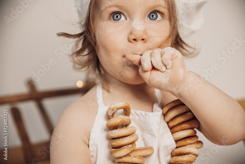 A little girl is a baker  preparing food.