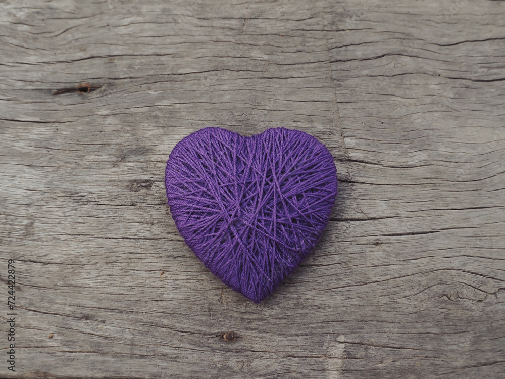 Obraz premium Yarn hearts on an old wooden background, vintage style for Valentine's Day.