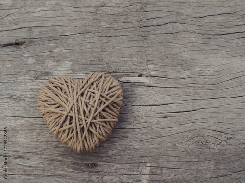 Yarn hearts on an old wooden background, vintage style for Valentine's Day.